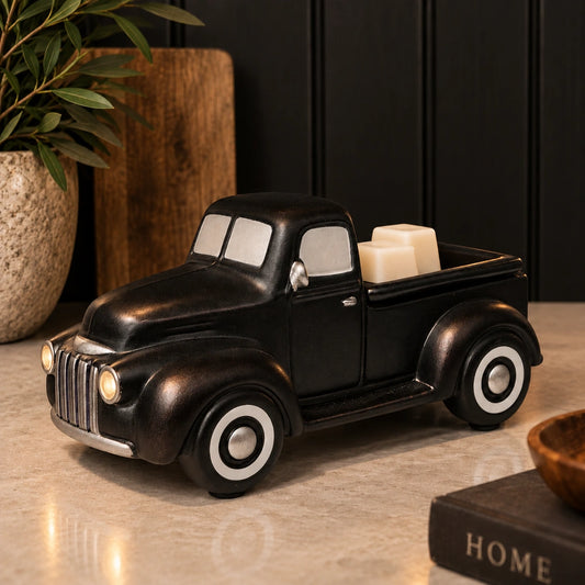 Black vintage truck wax warmer with cream wax melts and glowing headlights